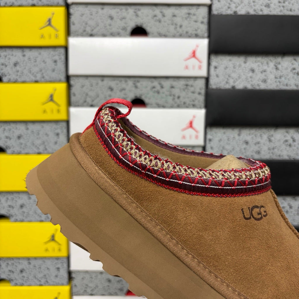 UGG Tazz Platform Slipper – Suede Mule with Shearling Lining, Red & Gold Braided Collar Trim, Red Pull Tab & Chunky Platform Sole in Chestnut